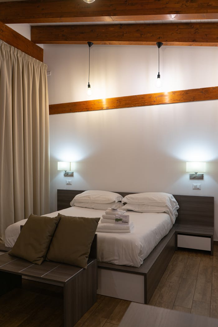 A cozy minimalist bedroom featuring modern wooden beams, ambient lighting, and elegant decor.
